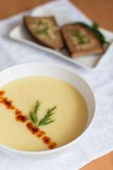 Home made potato cream soup with dry sweet pepper and toasts of black bread with cheese and fresh dill