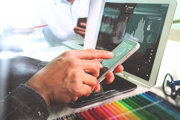 two colleague web designer discussing data and digital tablet an