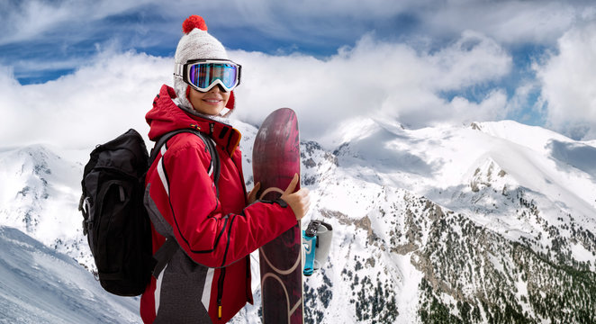 beautiful woman smiling and holding a snowboard