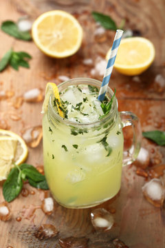 lemonade with mint and lemon on a wood background