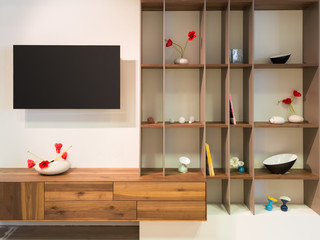 television on wall an wooden timber shelf units with decoration