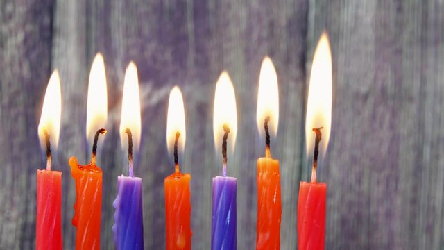 jewish holiday Hanukkah with menorah traditional and wooden dreidels spinning top . glitter overlay
