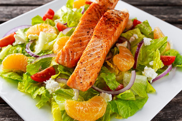 Fresh Orange Salmon salad with honey, tomatoes, onion, mandarin. healthy food concept.