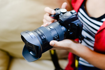 Closeup picture of woman hand holding camera and preview photos