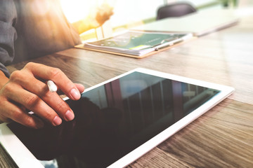 Businessman hand touching digital tablet.Photo finance manager w