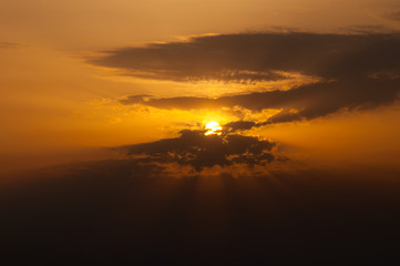 Sunlight protruding through clouds on sunny summer day