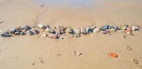 Stones on a sand beach in summer