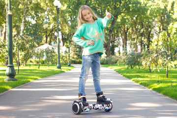 A little girl riding a electric scooter . Personal eco transport