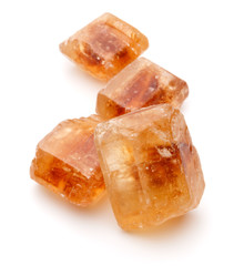 Brown caramelized lump cane sugar cube isolated on white backgro