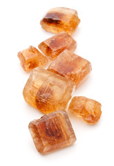 Brown caramelized lump cane sugar cube isolated on white backgro