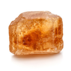 Brown caramelized lump cane sugar cube isolated on white backgro