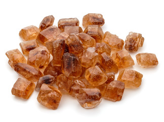 Brown caramelized lump cane sugar cube isolated on white backgro