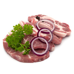 Raw pork neck chop meat with parsley herb leaves, peppercorn spi