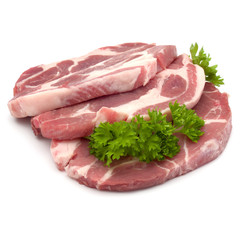 Raw pork neck chop meat with parsley herb leaves garnish isolate