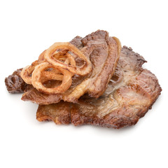Cooked fried pork meat with onion slices garnish isolated on whi