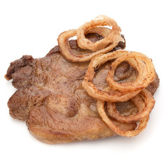 Cooked fried pork meat with onion slices garnish isolated on whi