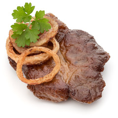 Cooked fried pork meat with parsley herb leaves and onion slices
