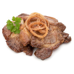 Cooked fried pork meat with parsley herb leaves and onion slices