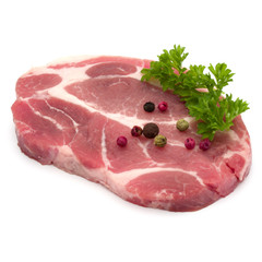 Raw pork neck chop meat with parsley herb leaves and peppercorn