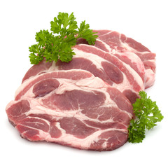Raw pork neck chop meat with parsley herb leaves garnish isolate