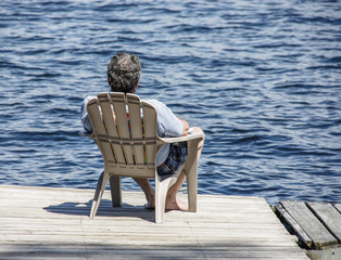 Man napping on dock in sunshine