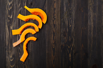 pumpkin slices on a black wooden background
