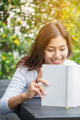 Asian women reading book in the garden