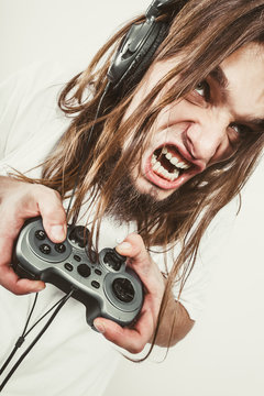 Stressed man playing on pad
