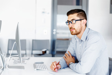 Male office worker sitting at desk