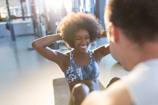 Athletic man and  afro american woman exercise in gym