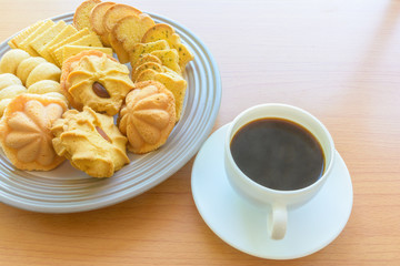 Black coffee with white cup and biscuits