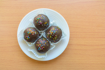 Brown chocolate on wooden table in top view