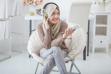 beautiful asian woman enjoying music