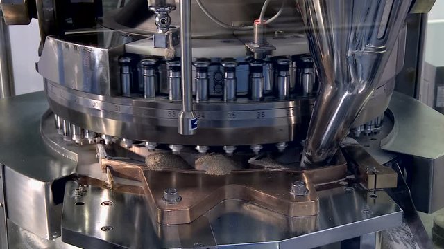 Pills falling out of pill manufacturing machine.