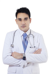 Confident young doctor standing in studio