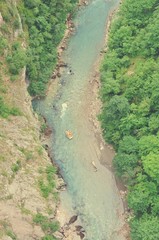 High angle view on the dramatic river canyon and rafters; shot from directly above. Tara river gorge, Durmitor, Montenegro. Image filtered in faded, retro, Instagram style. - 120370611