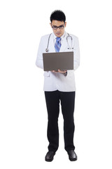Medical doctor works with laptop in studio