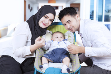 Muslim family and their son in stroller