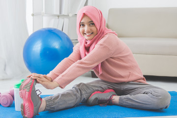 woman stretching while doing exercise at home
