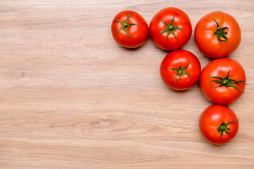red tomatoes on wooden ground