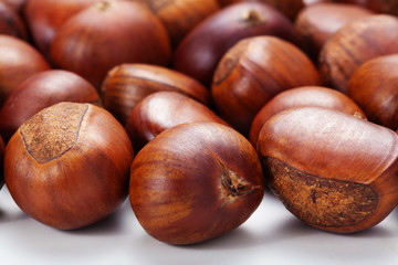Group of grilled chestnuts. Isolate on white background. Autumn background.