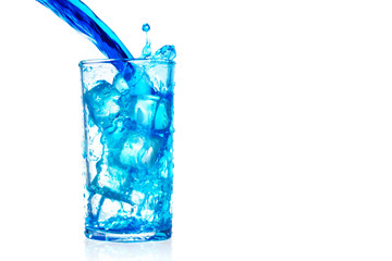 pouring blue water splash into glass isolated on white background with clipping path