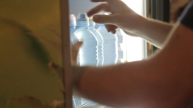 Ordering bottles in the refrigerator of supermarket