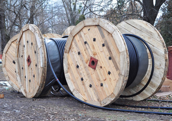 Wooden coil of electric cable and optical fibres on construction