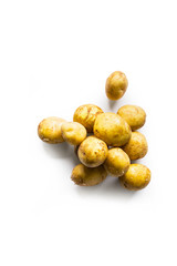 beautiful small rounded whole organic potatoes with the peel isolated on a white background seen from above