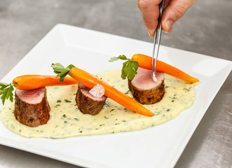Chef adding finishing touch on his dish