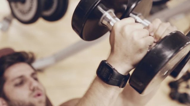 Young man with free weights at the gym
