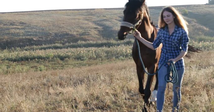 Woman lead horse walking field sunrise cowgirl countryside