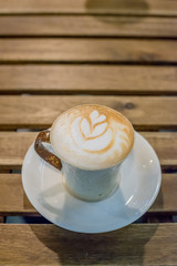 Cup of coffee latte art on wood table