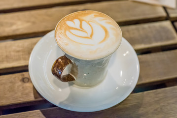Cup of coffee latte art on wood table